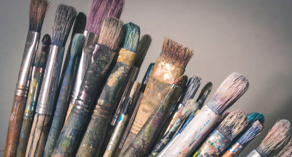 Paint brushes used in an art studio. Photo by Laura Adai on Unsplash