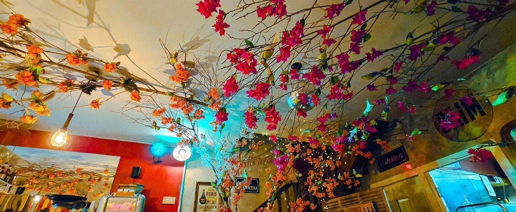 Floral branches and lights hanging across the ceiling inside Le Michel’s restaurant in Bordeaux.